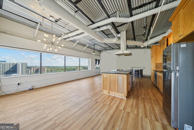 120 Ralph Mcgill Blvd NE Unit 1304 & 1305, Atlanta, GA 30308 - kitchen featuring freestanding refrigerator, a chandelier, dark countertops, light wood-style floors, and a center island