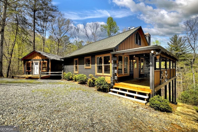 view of front of home featuring a shingled roof, board and batten siding, and covered porch