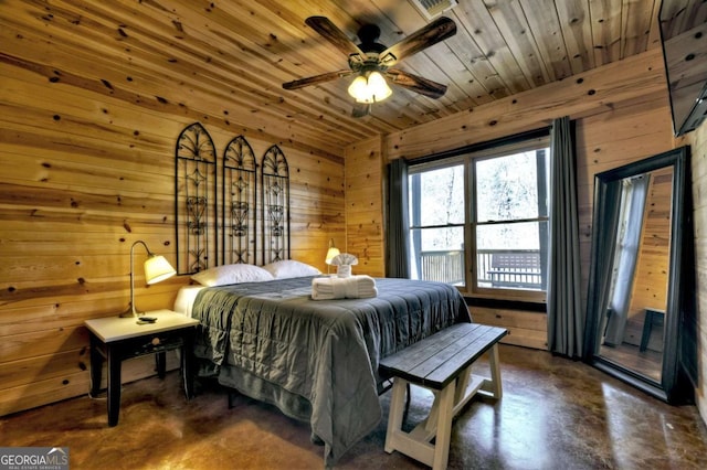 bedroom featuring wooden ceiling, finished concrete floors, and wooden walls
