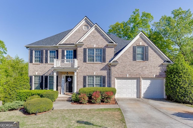 view of front of property with brick siding, an attached garage, a balcony, and concrete driveway