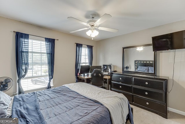 bedroom with ceiling fan and light carpet