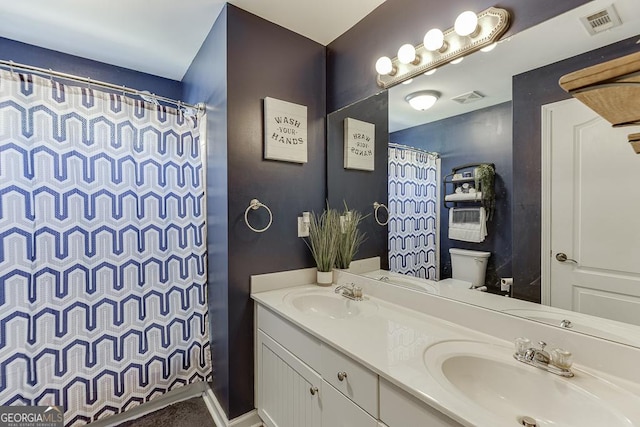 bathroom with a sink, visible vents, and toilet