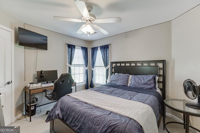 bedroom featuring light colored carpet, baseboards, and ceiling fan