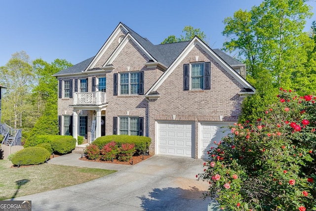 view of front of property featuring brick siding, a garage, concrete driveway, and a balcony