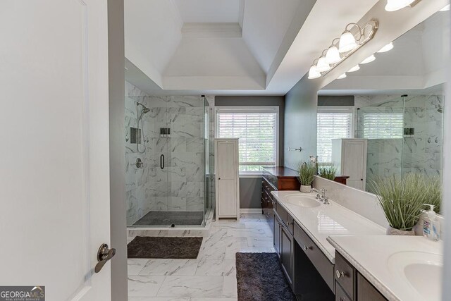 bathroom with a raised ceiling, marble finish floor, vanity, and a marble finish shower
