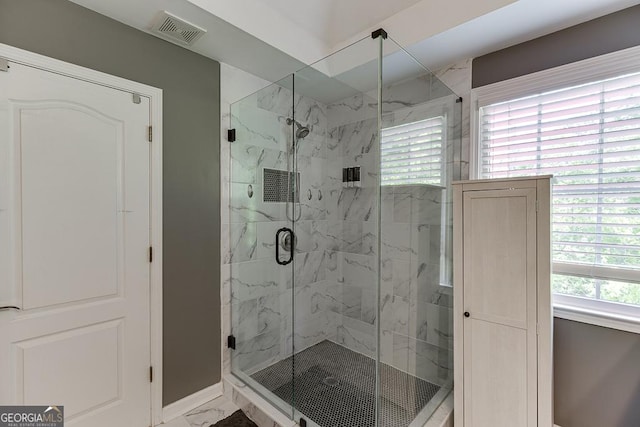 bathroom with visible vents, marble finish floor, baseboards, and a marble finish shower