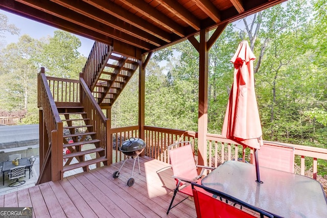 deck with stairway, outdoor dining area, and grilling area