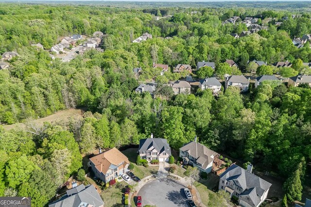 birds eye view of property with a residential view and a forest view