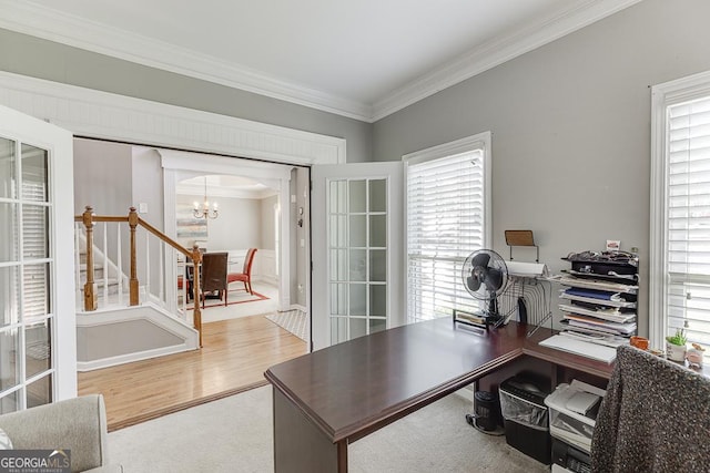 office space with a chandelier, wood finished floors, ornamental molding, and a wealth of natural light