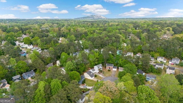 drone / aerial view with a wooded view