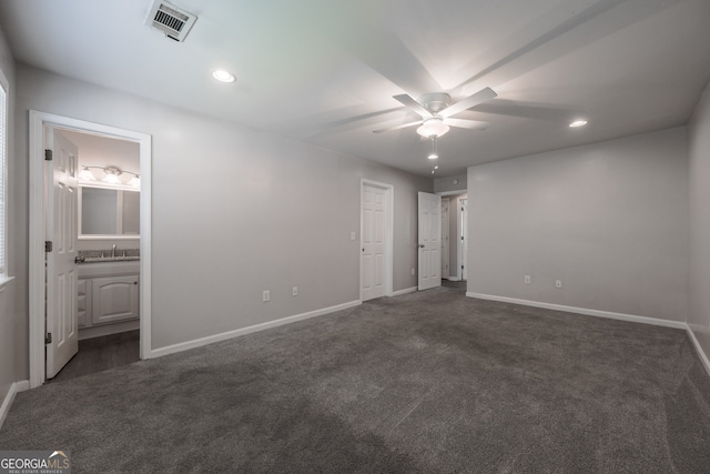 unfurnished bedroom with baseboards, dark carpet, and recessed lighting