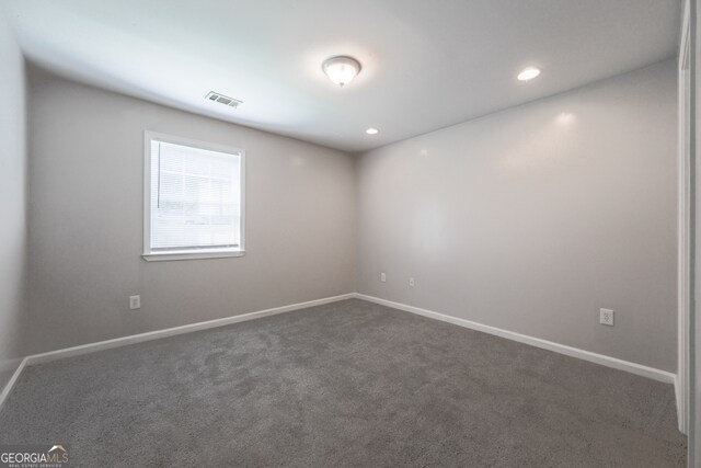carpeted empty room with baseboards, visible vents, and recessed lighting