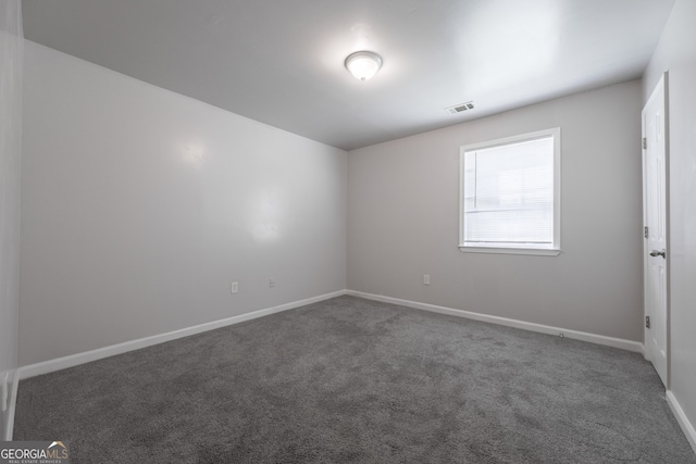 carpeted empty room with visible vents and baseboards