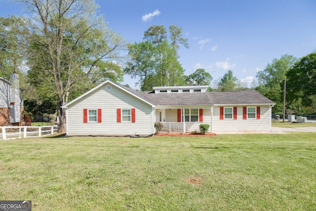 view of front of house with a front yard, covered porch, and fence