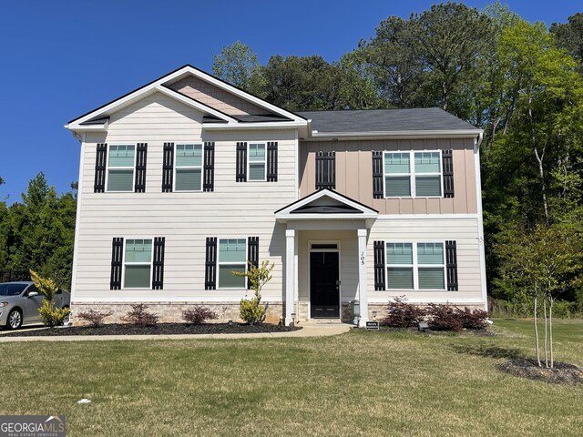 205 Sullivan St, Hampton, GA 30228 - view of front of home with a front lawn and board and batten siding