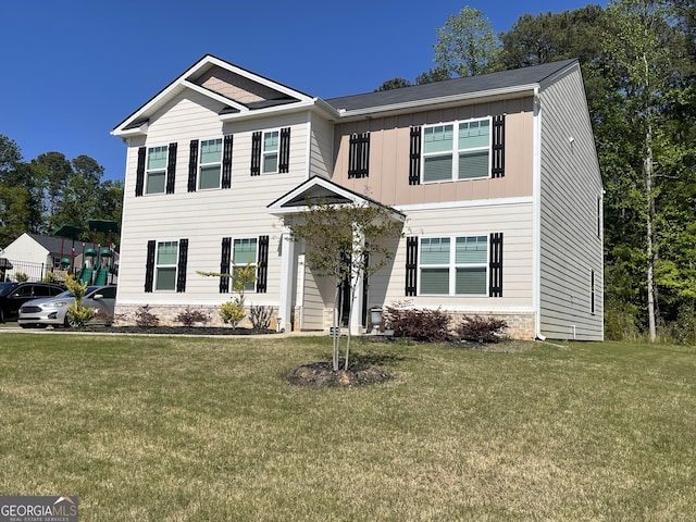 205 Sullivan St, Hampton, GA 30228 - view of front of home featuring board and batten siding and a front lawn