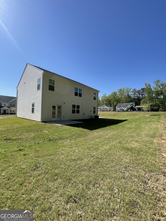 205 Sullivan St, Hampton, GA 30228 - back of house with a yard, a playground, and a patio