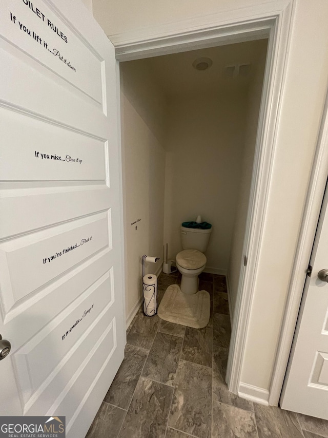 205 Sullivan St, Hampton, GA 30228 - bathroom with toilet and baseboards