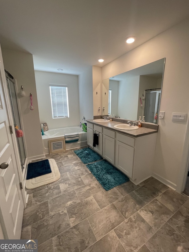 205 Sullivan St, Hampton, GA 30228 - full bathroom featuring a stall shower, a bath, double vanity, stone finish flooring, and recessed lighting
