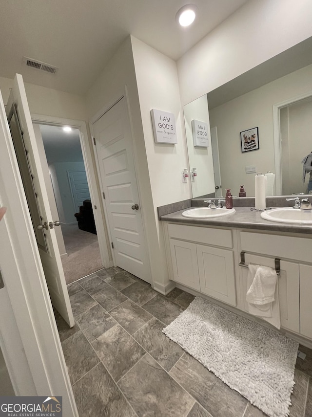 205 Sullivan St, Hampton, GA 30228 - bathroom featuring double vanity and stone finish flooring