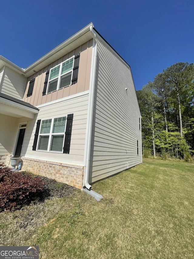 205 Sullivan St, Hampton, GA 30228 - view of home's exterior with a yard, board and batten siding, and stone siding