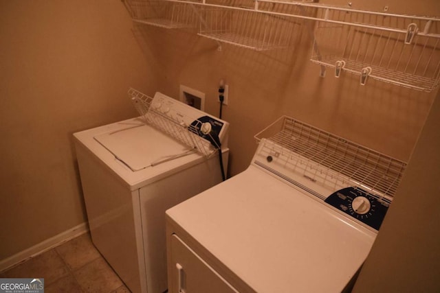 laundry room featuring independent washer and dryer, baseboards, and tile patterned flooring