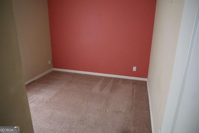 carpeted empty room with baseboards