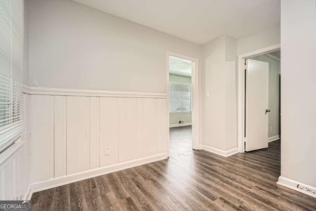 1105 S Parkwood Dr, Forest Park, GA 30297 - unfurnished room with a decorative wall, wainscoting, and wood finished floors