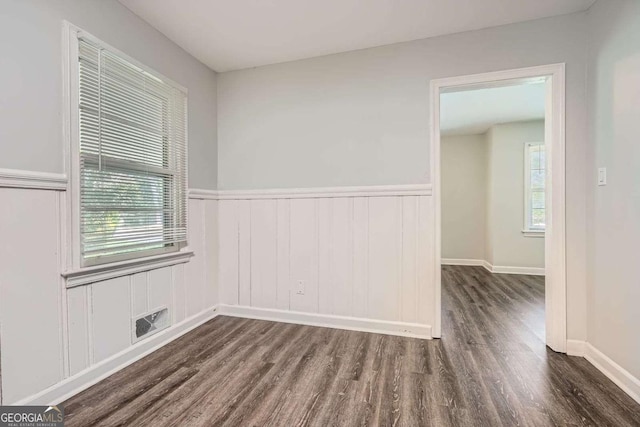 1105 S Parkwood Dr, Forest Park, GA 30297 - spare room featuring visible vents, a wainscoted wall, and wood finished floors
