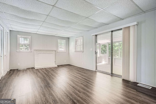 1105 S Parkwood Dr, Forest Park, GA 30297 - unfurnished living room featuring visible vents, a wealth of natural light, a drop ceiling, and wood finished floors