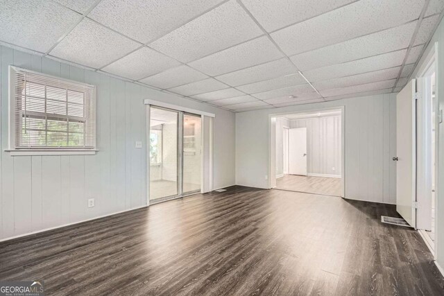 1105 S Parkwood Dr, Forest Park, GA 30297 - unfurnished living room with dark wood-style flooring, baseboards, and a paneled ceiling