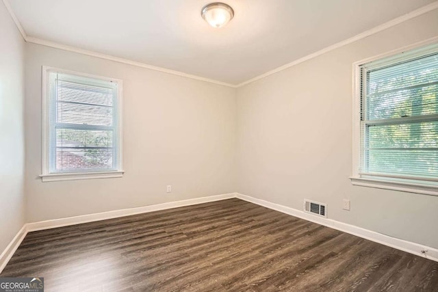 1105 S Parkwood Dr, Forest Park, GA 30297 - unfurnished room with a wealth of natural light, visible vents, ornamental molding, and dark wood-style floors
