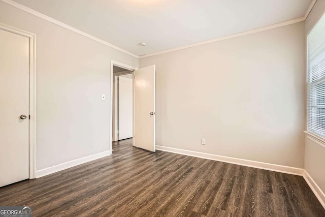 1105 S Parkwood Dr, Forest Park, GA 30297 - unfurnished bedroom featuring dark wood-style floors, baseboards, and crown molding
