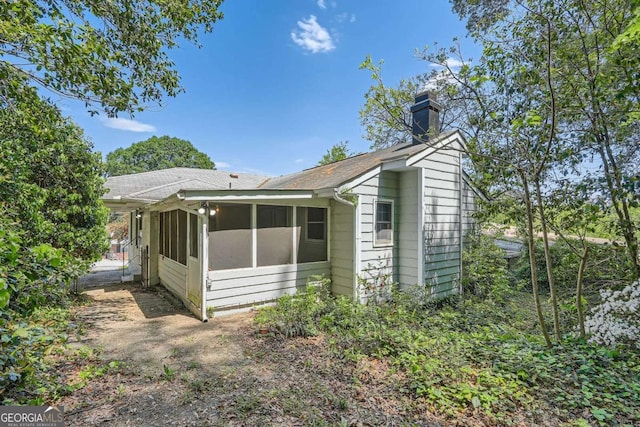 1105 S Parkwood Dr, Forest Park, GA 30297 - view of home's exterior featuring a sunroom and a chimney