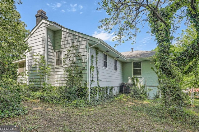 1105 S Parkwood Dr, Forest Park, GA 30297 - view of side of property featuring cooling unit and a chimney