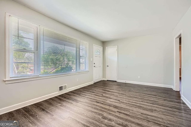 1105 S Parkwood Dr, Forest Park, GA 30297 - empty room featuring plenty of natural light, visible vents, and dark wood finished floors