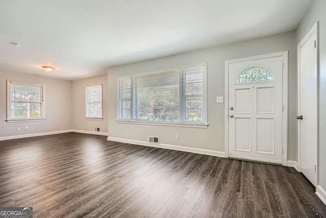 1105 S Parkwood Dr, Forest Park, GA 30297 - foyer entrance with visible vents, a wealth of natural light, baseboards, and dark wood-style floors