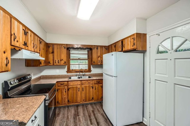 1105 S Parkwood Dr, Forest Park, GA 30297 - kitchen featuring a sink, stainless steel electric stove, freestanding refrigerator, under cabinet range hood, and brown cabinets