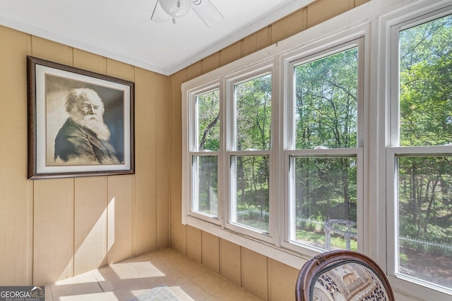 interior space with ceiling fan