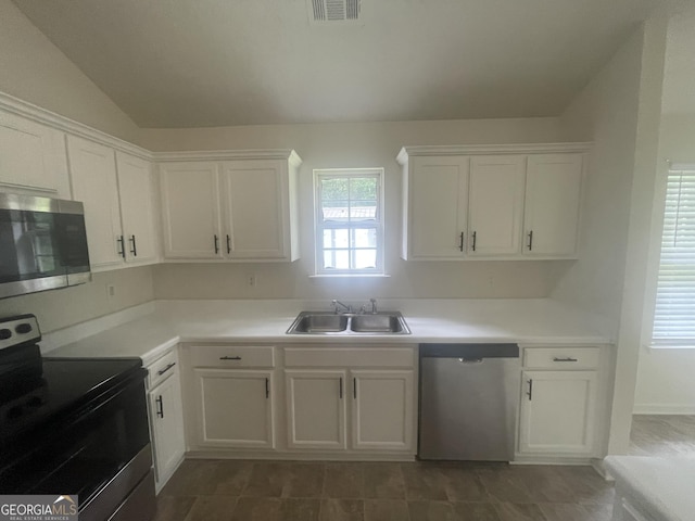 460 Mckneely Rd, Griffin, GA 30224 - kitchen with appliances with stainless steel finishes, a sink, white cabinets, light countertops, and vaulted ceiling