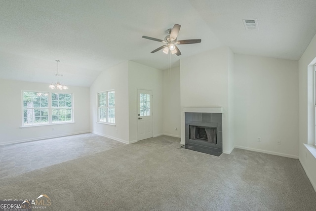 460 Mckneely Rd, Griffin, GA 30224 - unfurnished living room with vaulted ceiling, a tiled fireplace, a ceiling fan, carpet flooring, and a chandelier