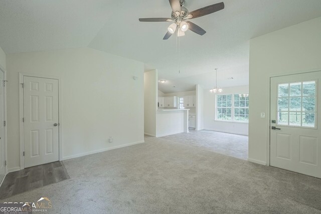 460 Mckneely Rd, Griffin, GA 30224 - unfurnished living room with carpet, ceiling fan with notable chandelier, baseboards, and lofted ceiling