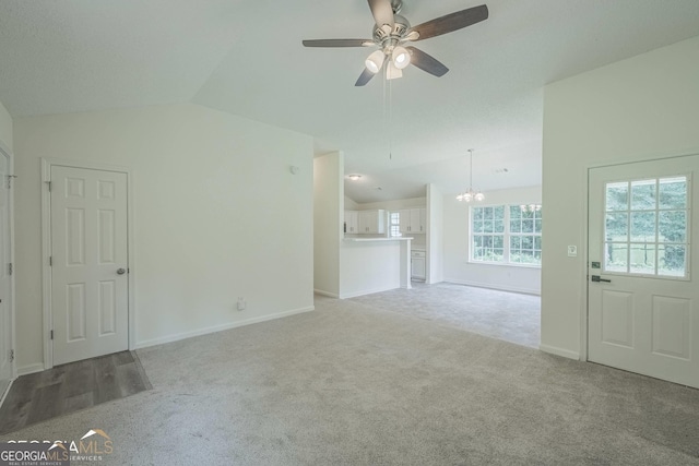 460 Mckneely Rd, Griffin, GA 30224 - unfurnished living room with a chandelier, carpet floors, a ceiling fan, vaulted ceiling, and baseboards