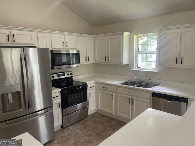 460 Mckneely Rd, Griffin, GA 30224 - kitchen with stainless steel appliances, a sink, white cabinetry, light countertops, and lofted ceiling