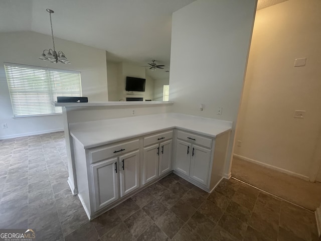 460 Mckneely Rd, Griffin, GA 30224 - kitchen featuring a chandelier, vaulted ceiling, baseboards, light countertops, and a peninsula