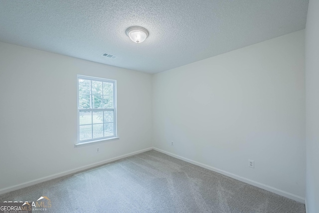 460 Mckneely Rd, Griffin, GA 30224 - spare room featuring a textured ceiling, carpet flooring, baseboards, and visible vents