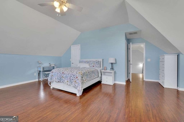 bedroom with a ceiling fan, visible vents, wood finished floors, lofted ceiling, and baseboards