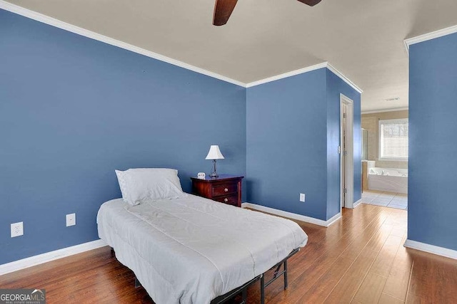 bedroom featuring baseboards, crown molding, a ceiling fan, and wood finished floors