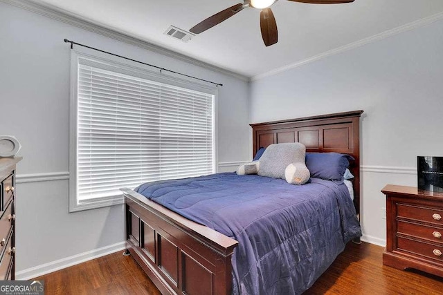 bedroom featuring crown molding, a ceiling fan, visible vents, baseboards, and dark wood-style floors