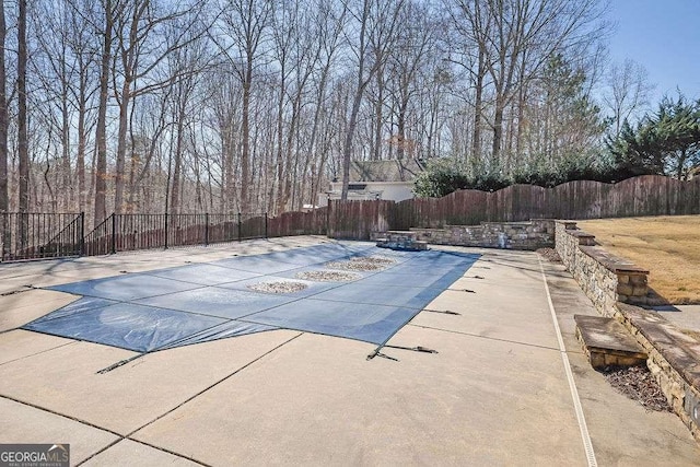 view of pool featuring a patio area, a fenced in pool, and fence
